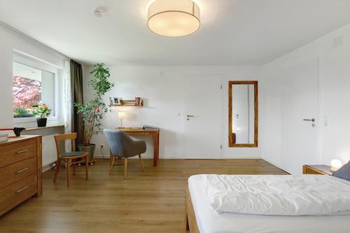 a bedroom with a bed and a desk and a chair at Ferienwohnung Staffe in Bonndorf im Schwarzwald