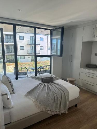 a bedroom with a large bed and a large window at Harbour view-Sleeps 4-Sea View-Parking-Balcony in Ramsgate