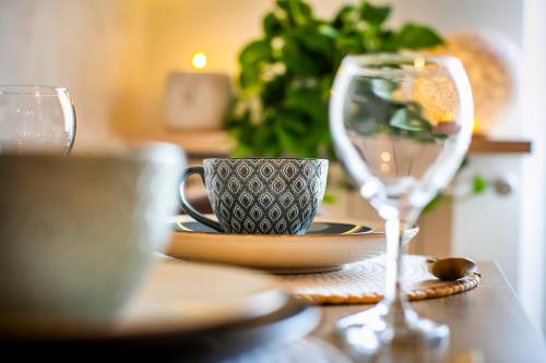 a table with a coffee cup and a wine glass at 10FLOOR Private Parking in Como