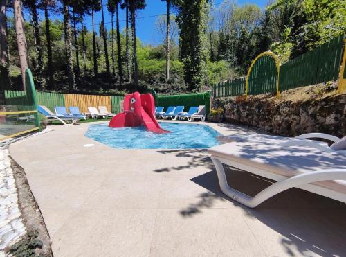 a small pool with a slide in a backyard at Hotel & Spa Tino Sveti Stefan in Ohrid