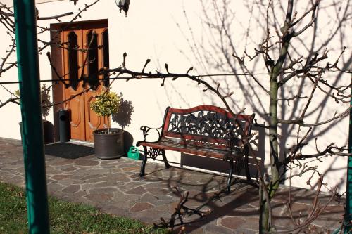 a bench sitting in front of a building with a door at Penzion U Vlků in Valtice