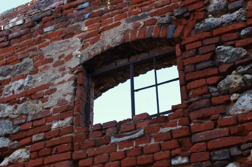 a brick wall with a window in it at Penzion U Vlků in Valtice