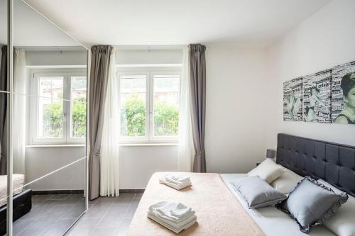 a bedroom with a large bed and a mirror at Lovely Tiresia Apartment in Sperlonga
