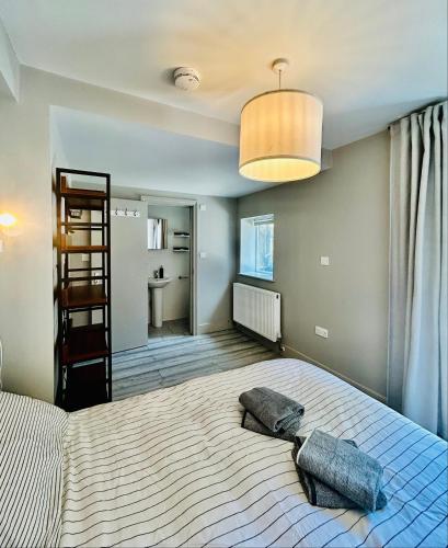 a bedroom with a large bed with two pillows on it at Heart of Dalston East London in London