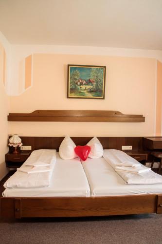 a bedroom with a bed with a red heart on it at BE ME Black Forest Family Apartment -Zum Letzten G'Stehr in Bad Rippoldsau