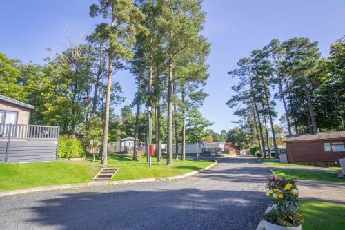 a street in a residential neighborhood with trees at Travellers Rest Retreat in Oxnam