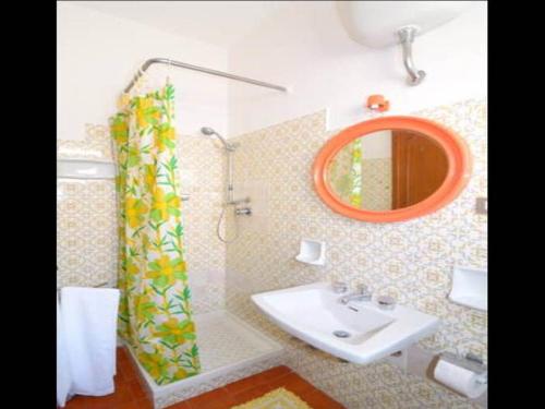 a bathroom with a sink and a mirror at Holiday Home Alessia n 3 ,Centro Storico di Taormina in Taormina
