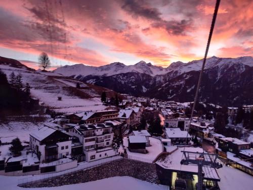 a view of a town in the snow at sunset at Hotel Garni Zerzer in Serfaus