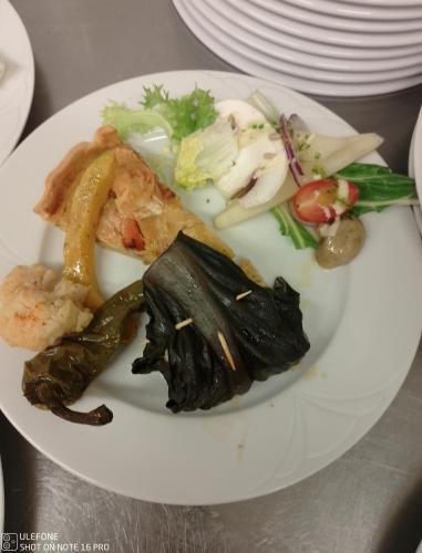 a plate of food with seafood and vegetables on a table at Auberge du Montcalm in Auzat