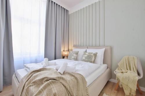 a white bed in a room with a window at TINTURA by BAST - Wanna, Antresola, OFF Piotrkowska, EC1 ,Stajnia Jednorożca, Winda, Parking na Terenie, Orientarium, Hopa Lupa, ATLAS ARENA in Łódź