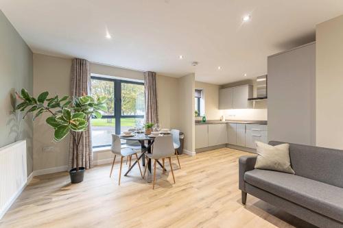 a living room with a table and a couch at Maple Apartments - Stylish 1 Bed Apartment in Derby in Derby