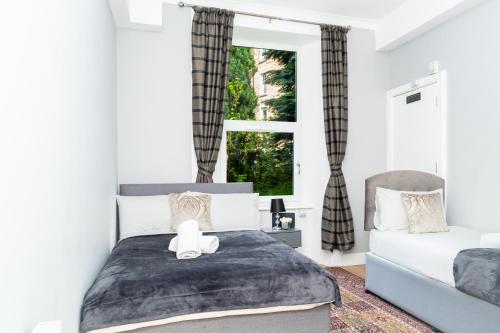 a bedroom with a bed with a teddy bear on it at 3BR Home Next to Stadium Near Airport Sleeps 7 in Edinburgh