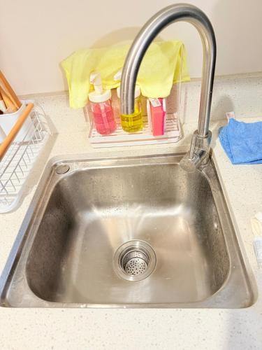 a sink with a faucet in a kitchen at WAYNderer's Haven in Davao City