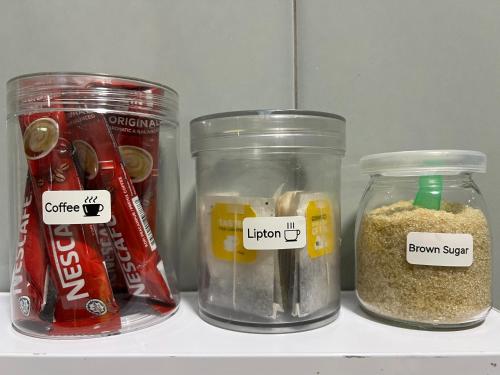three jars of food on a shelf in a refrigerator at Simply Staycation Palm Garden in Lahad Datu