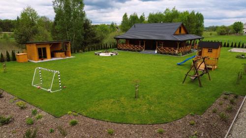 an aerial view of a backyard with a house and a playground at Dom nad stawem in Biłgoraj