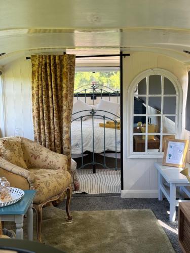 a living room with a couch and a window at The Bus On The Hill in Huntsham