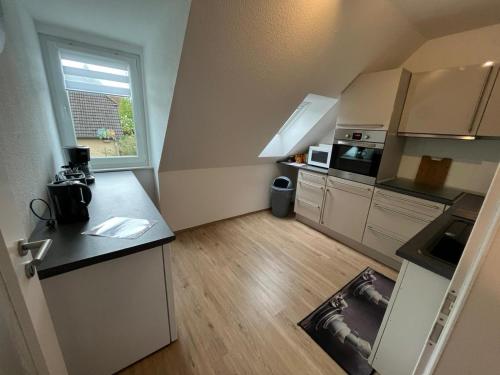 a small kitchen with a counter and a window at Ferienwohnung Sonnenschein Gartenblick in Uelzen