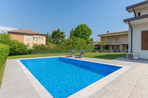 a swimming pool in the backyard of a house at Villa Imperiale - Private Pool & Relax in Desenzano del Garda