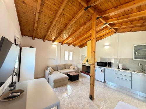 a large living room with a couch and a kitchen at ATHENS AIRPORT - SEASIDE STUDIO - Artemida in Artemida