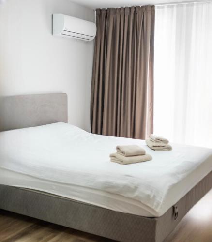a bedroom with a bed with towels on it at ТОП Апартаменти в Панорама Парк in Plovdiv