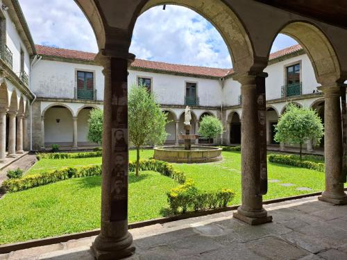 an external view of a building with a garden at Boanova Guesthouse Convento Cucujães in Oliveira de Azemeis