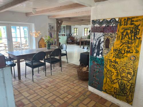 a dining room with a table and chairs in it at The Fishermen's House - charming and close to beach in Thisted