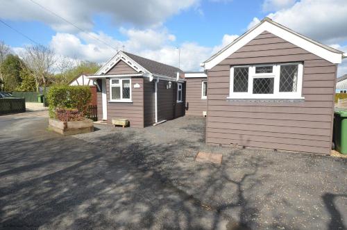 a small house in a yard with a driveway at The Moorings in Wroxham