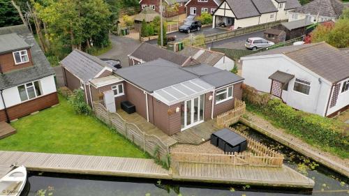 an aerial view of a house on the water at The Moorings in Wroxham