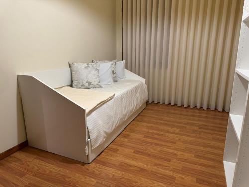 a bed with two pillows on it in a room at Varandas do Tâmega by Alotur in Mondim de Basto