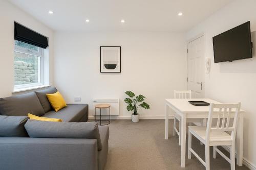 a living room with a couch and a table at 6 Person Apartment in City Centre in Cardiff