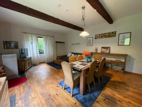a living room with a table and chairs and a couch at Domaine La Gazaille de Camille in Le Temple-sur-Lot
