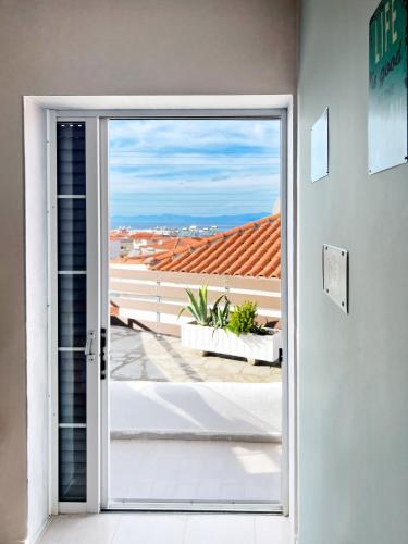 a door leading to a balcony with a view at Rona Vista Suites cozy veranda in Polykhrono