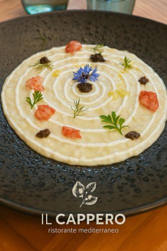 a pie with a flower on top of it on a table at Villa Totò Resort in Cefalù