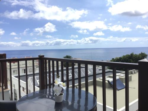 a table on a balcony with a view of the ocean at Huerta Nueva 2º Izquierda in Santa Cruz de la Palma