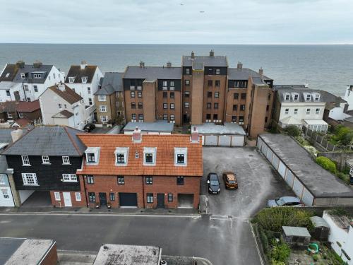 an aerial view of a city with buildings and the ocean at Pebble Beach by the Sea in Deal