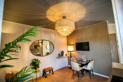 a dining room with a table and a chandelier at 10FLOOR Private Parking in Como
