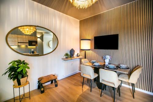a dining room with a table and a mirror at 10FLOOR Private Parking in Como