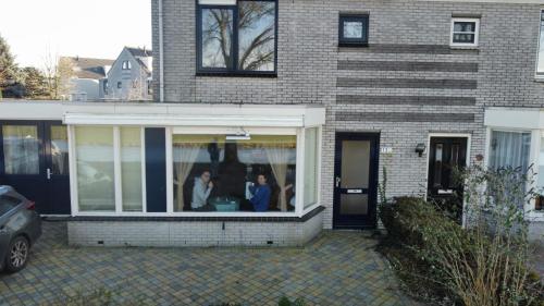 two people are standing in a window of a house at Volendam in Volendam