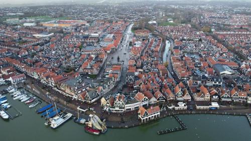 an aerial view of a city with boats in the water at Volendam in Volendam