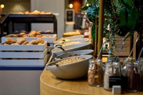 a table with a bunch of pastries on it at Scandic Nürnberg Central in Nürnberg