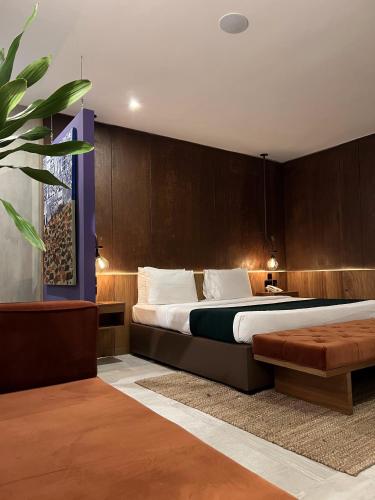 a bedroom with a large bed and a couch at The Borough Lagos in Lagos