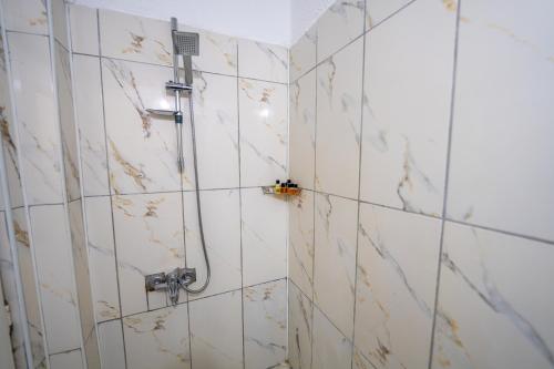 a bathroom with a shower with marble tiles at hotels crazy horse in Ortahisar
