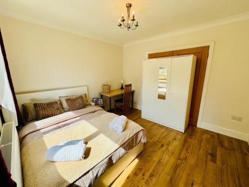 a bedroom with a bed with two towels on it at Urban Garden Hideaway in Dublin