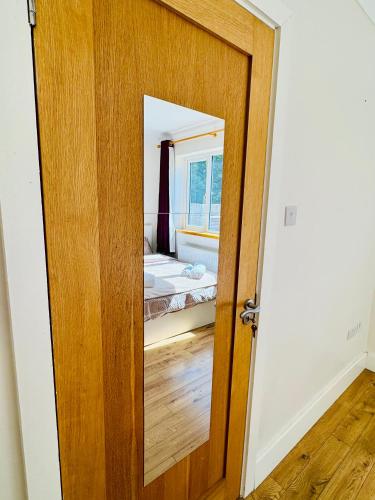 a door leading to a bedroom with a bed at Urban Garden Hideaway in Dublin