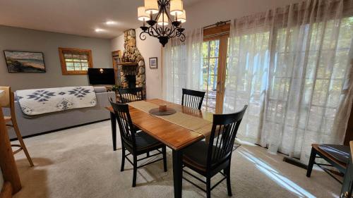 a dining room with a table and chairs and a bedroom at Woods Way Hideaway - minutes from Petoskey & Harbor Springs - close to beaches, skiing & more! in Petoskey