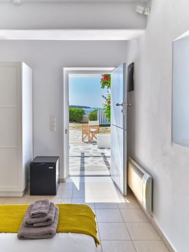 a bedroom with a bed and a door leading to a patio at ARIADNI Lux villa with 180 panoramic sea view in Drios