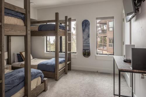 a dorm room with bunk beds and a desk at Beaverhead Condo - 5 Slalom #301 in Big Sky