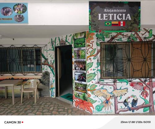 a building with a colorful wall with a sign on it at Alojamiento LETICIA in Leticia