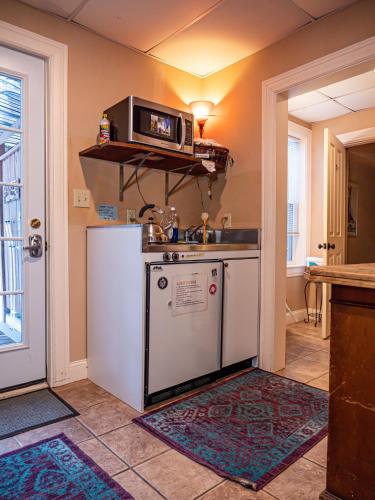 a kitchen with a sink and a microwave at The Notch Hostel in North Woodstock