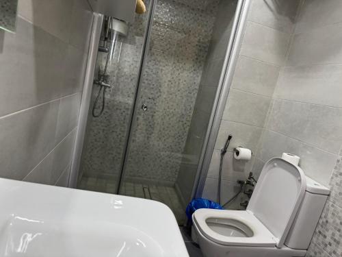 a bathroom with a shower with a toilet and a sink at Studio Appartement MIRAMAR in Mohammedia